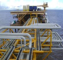 Offshore platform deck with interconnected piping runs and lifting cranes