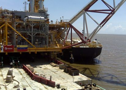 Offshore platform base under construction beside a support barge